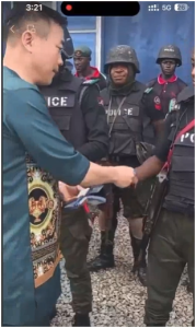 Outrage as Video Shows Chinese Giving Cash to Nigerian Policemen in Uniform