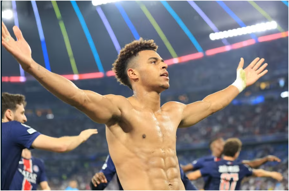 Désiré Doué lifts the UEFA Champions League trophy after inspiring PSG to a record-breaking 5-0 final win over Inter Milan in Munich.
